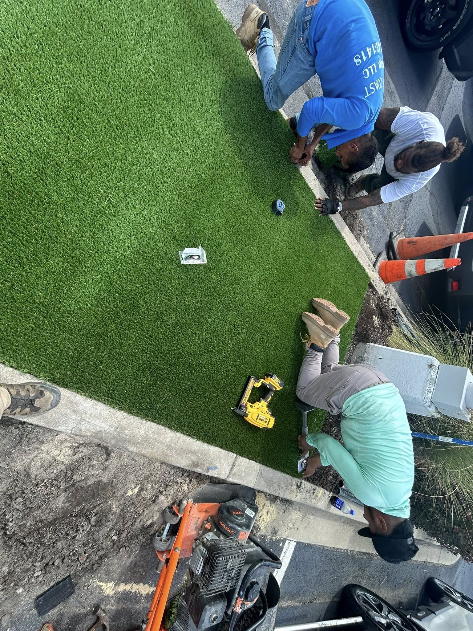 Removed shrubs, and installed artificial turf for dealership