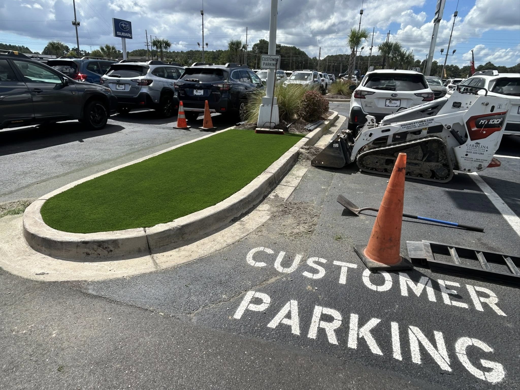 Removed shrubs, and installed artificial turf for dealership