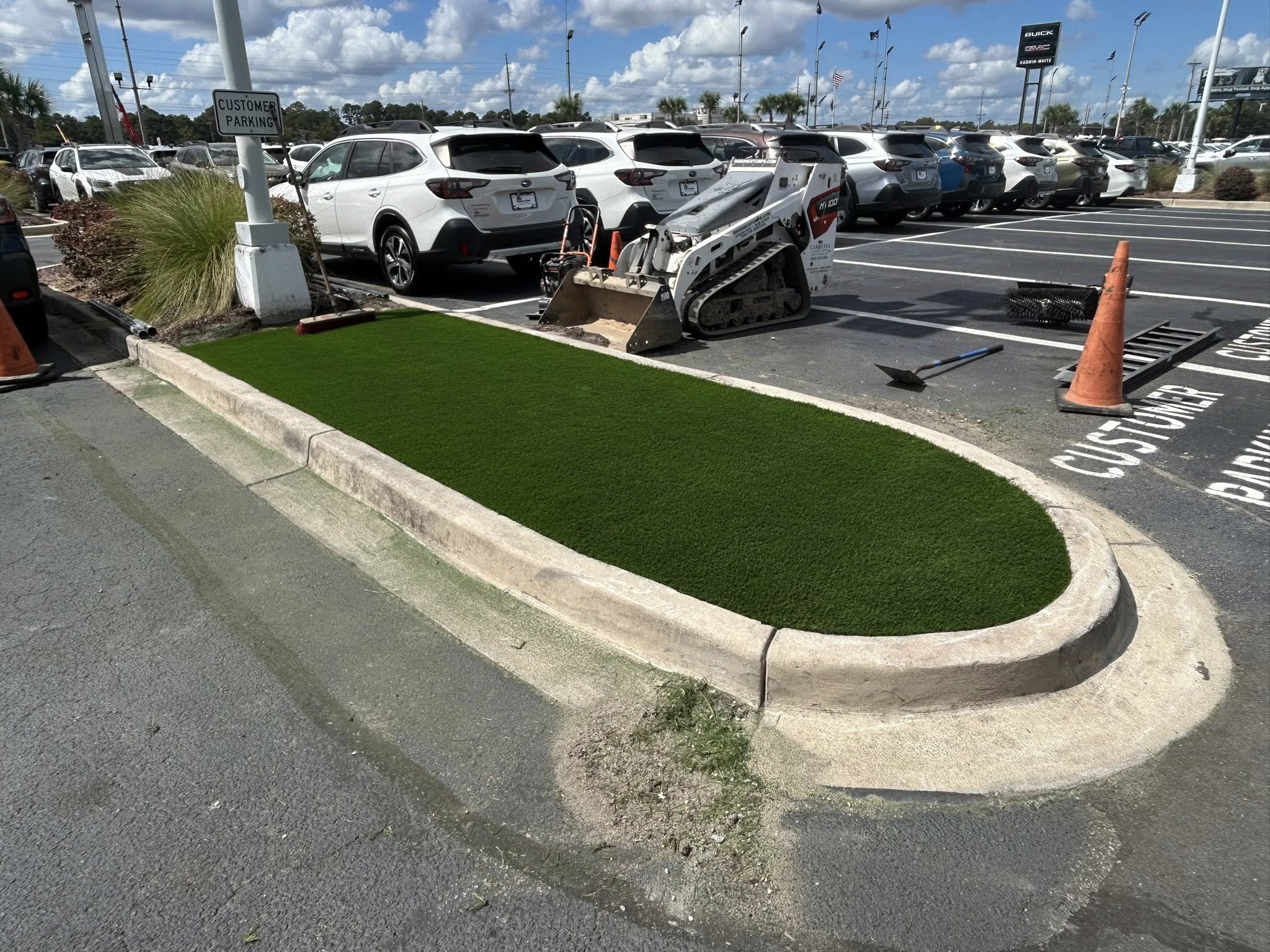 Removed shrubs, and installed artificial turf for dealership