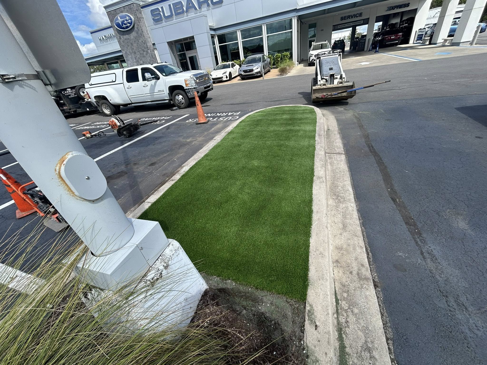 Removed shrubs, and installed artificial turf for dealership