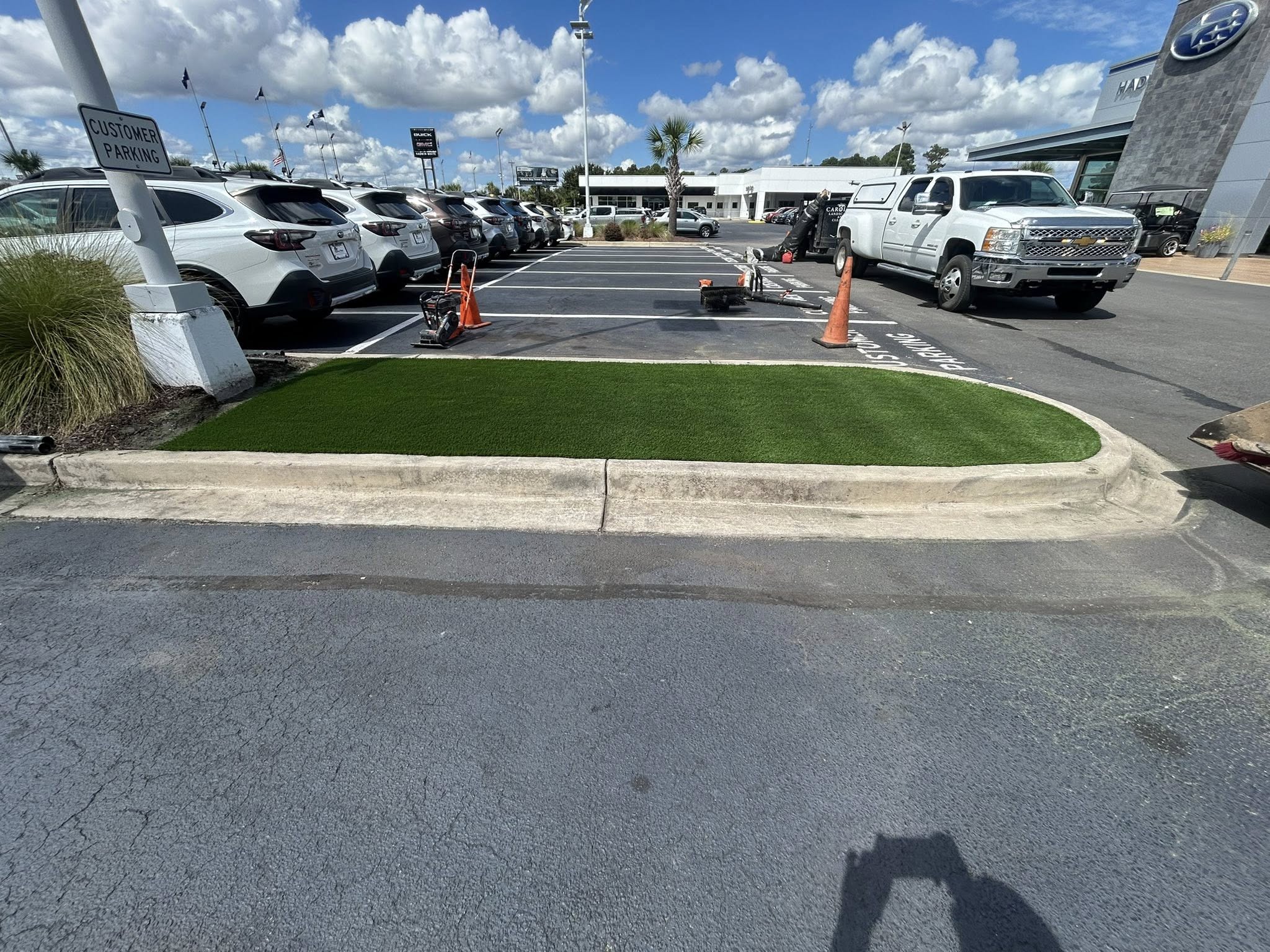 Removed shrubs, and installed artificial turf for dealership