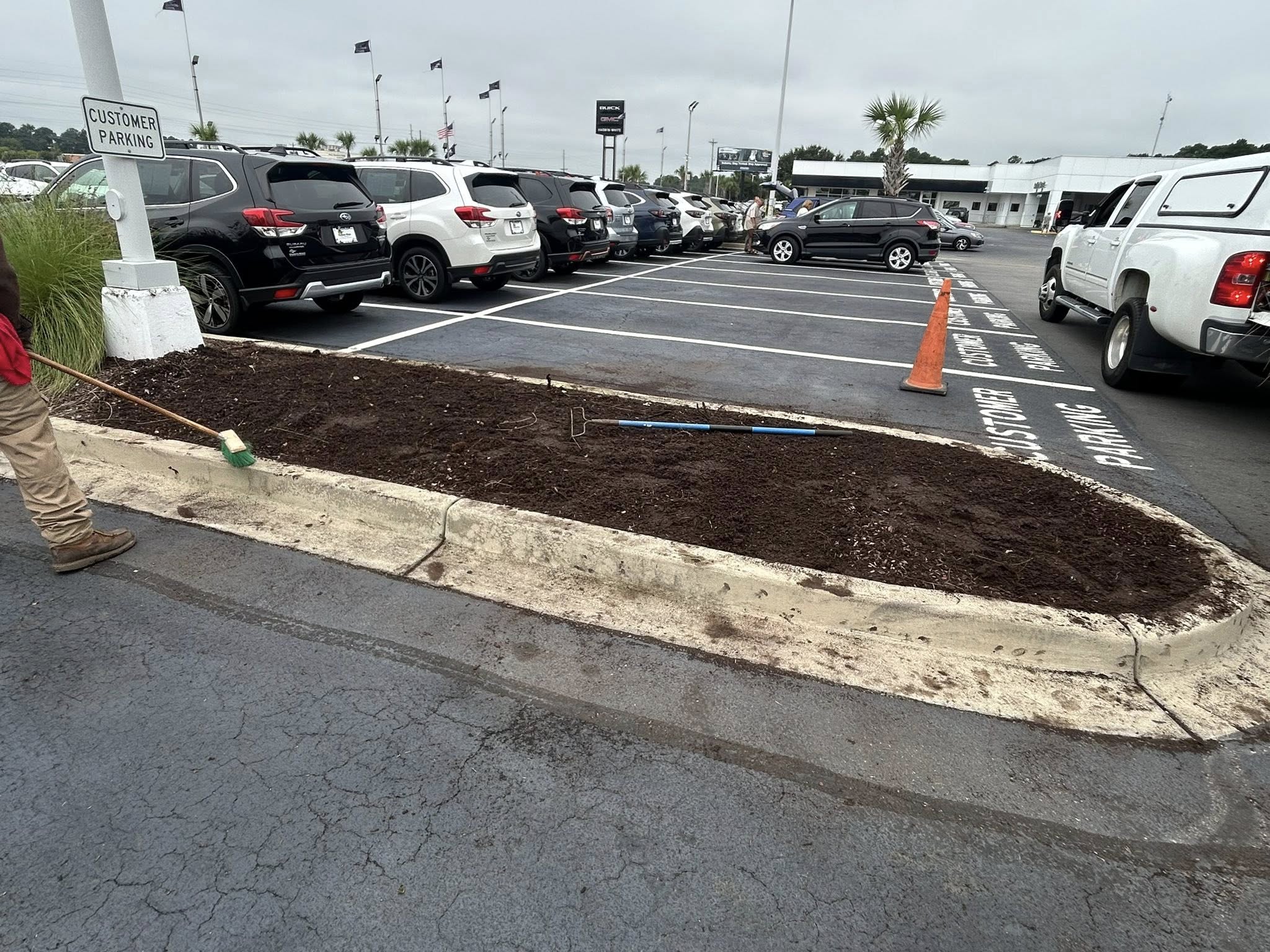 Removed shrubs, and installed artificial turf for dealership