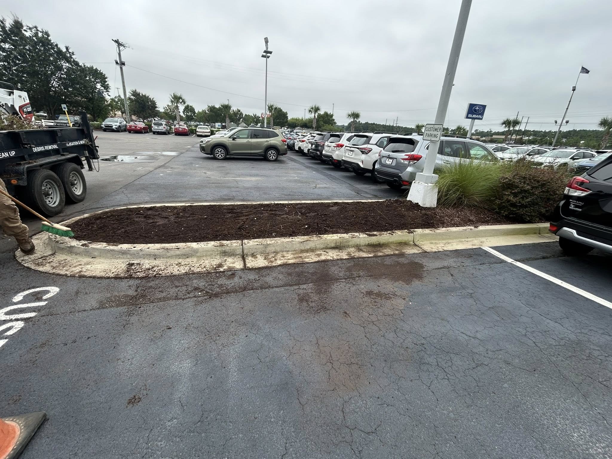 Removed shrubs, and installed artificial turf for dealership