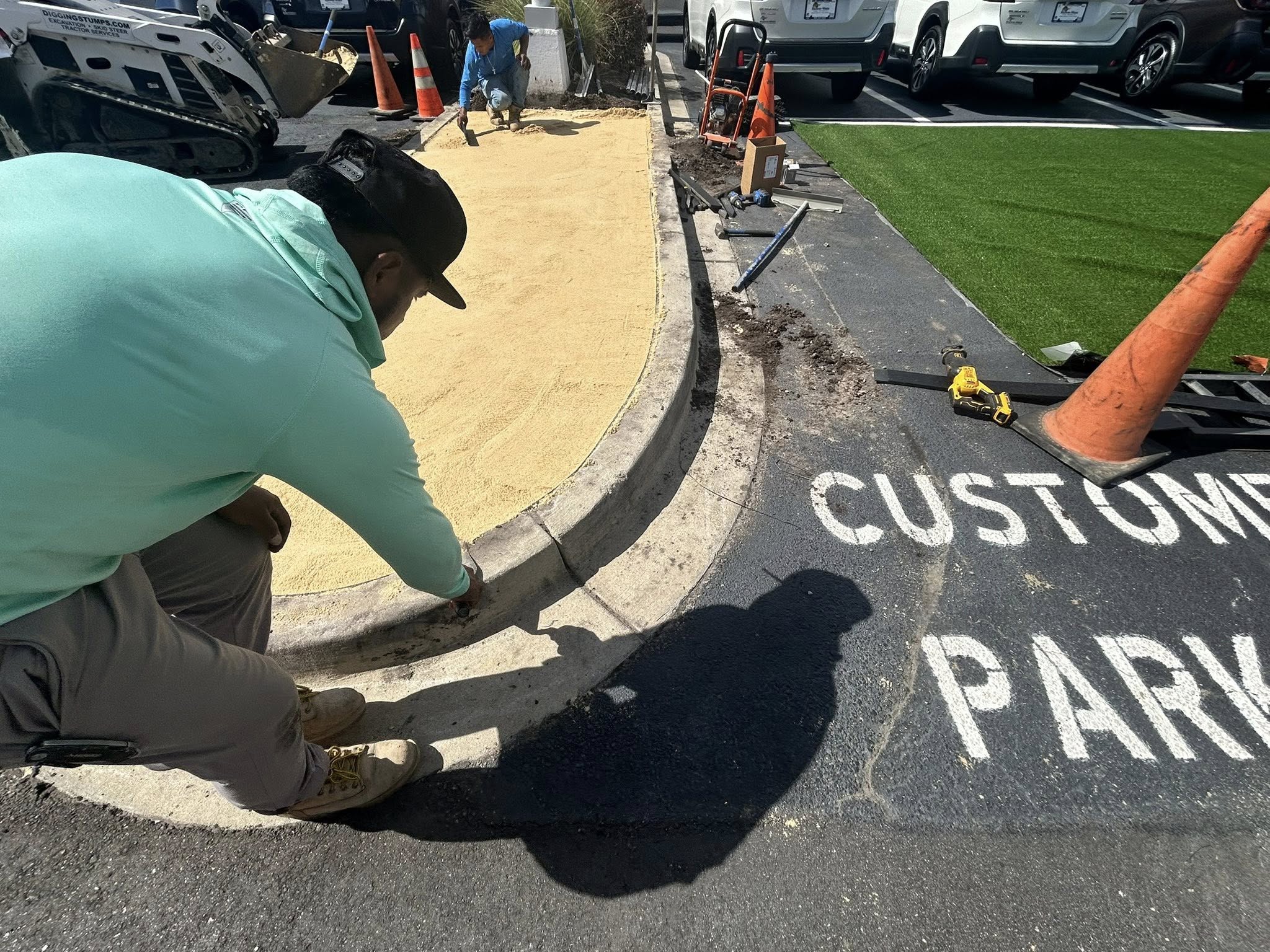 Removed shrubs, and installed artificial turf for dealership